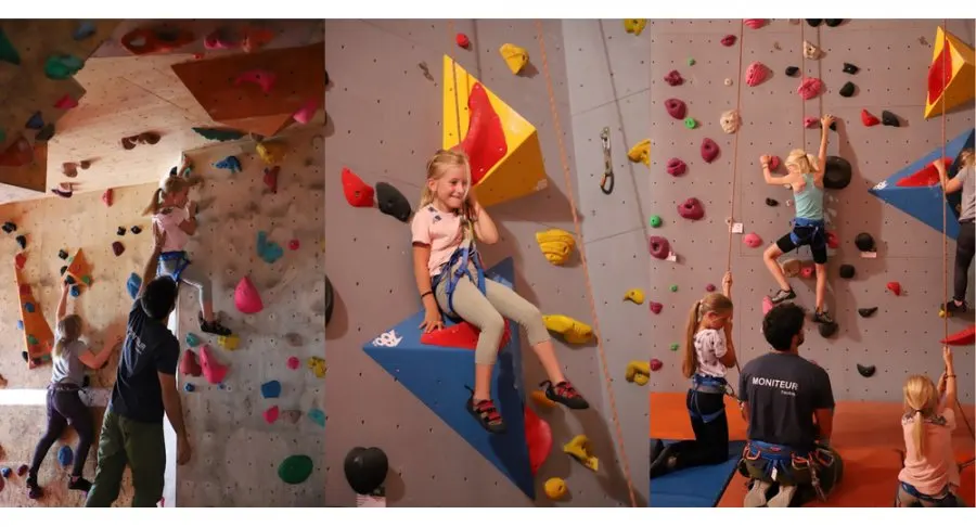 Le moniteur accompagne les enfants au pied du mur